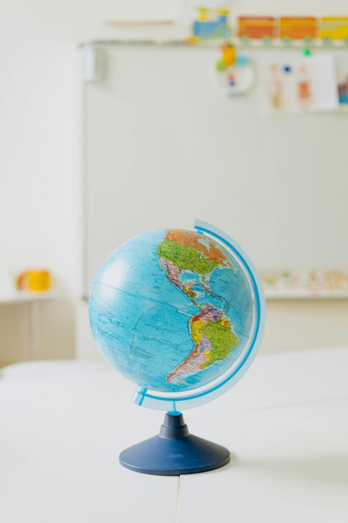 Colorful globe model placed on a classroom table, ideal for educational themes.
